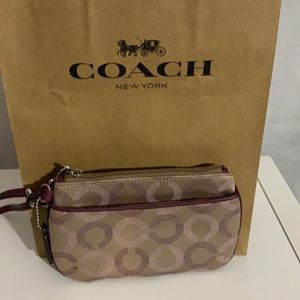 Coach wristlet with purple trim leather